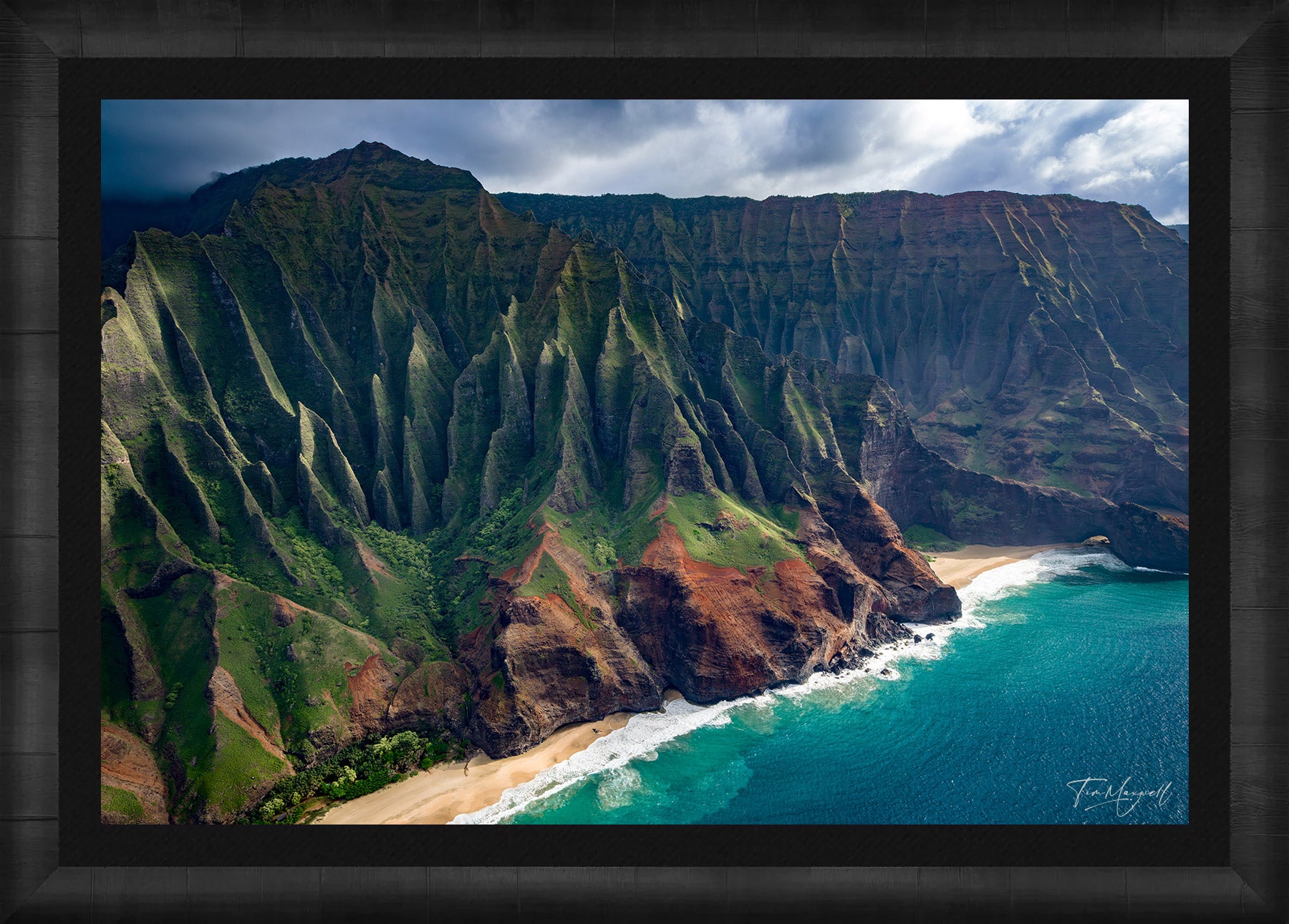 Aerial photograph of Kauai’s Na Pali Coast featuring dramatic green cliffs and turquoise ocean, displayed in an elegant ROMA Moulding wood frame.
