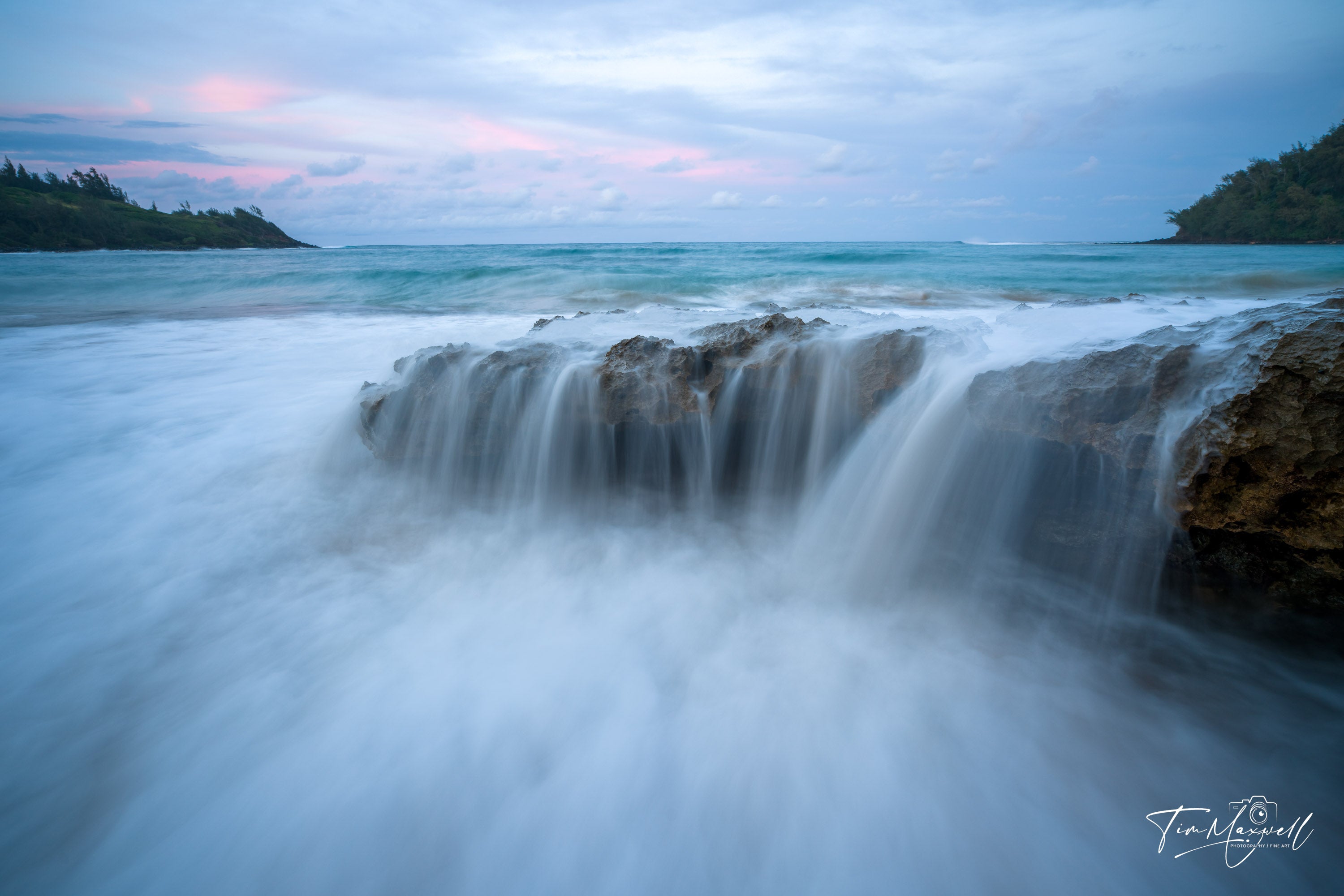 Long-exposure photo of waves cascading over volcanic rock at sunset in Kauai, fine art print by Tim Maxwell.