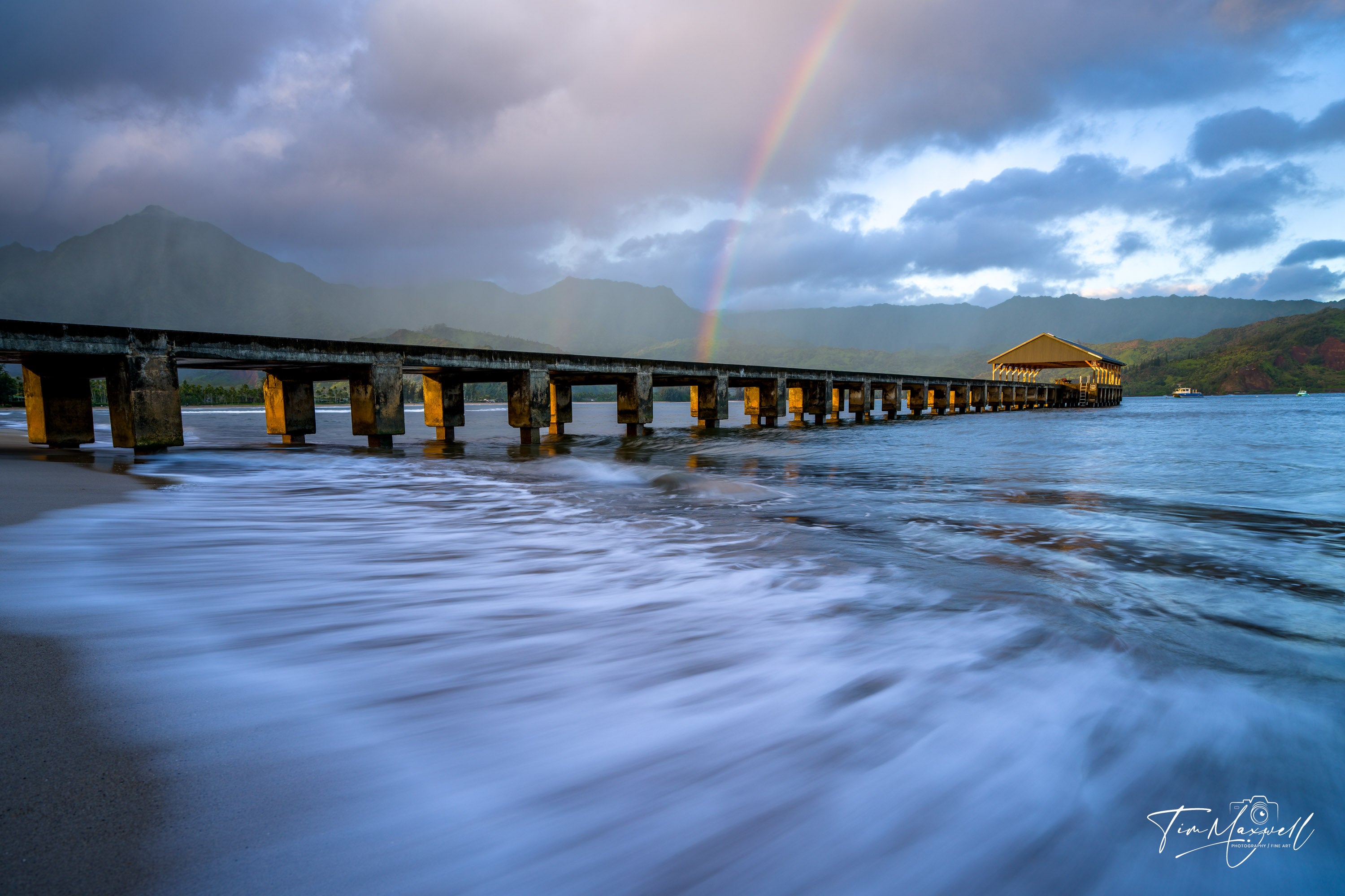 Sunrise rainbow over Hanalei Pier in Kauai, fine art print by Tim Maxwell.