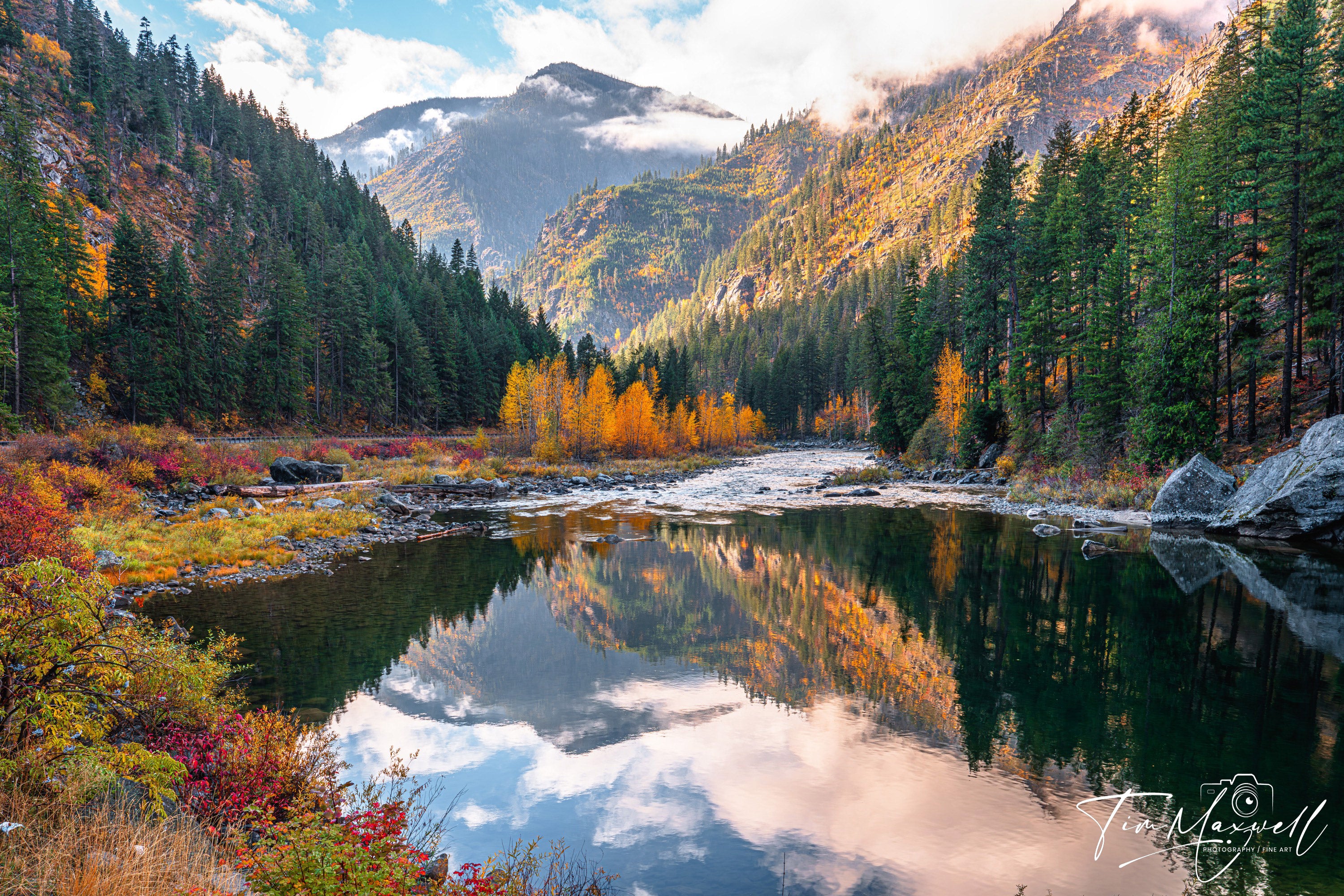 Vibrant autumn foliage and mountain reflections along the Wenatchee River in Tumwater Canyon, Washington; fine art print by Tim Maxwell.