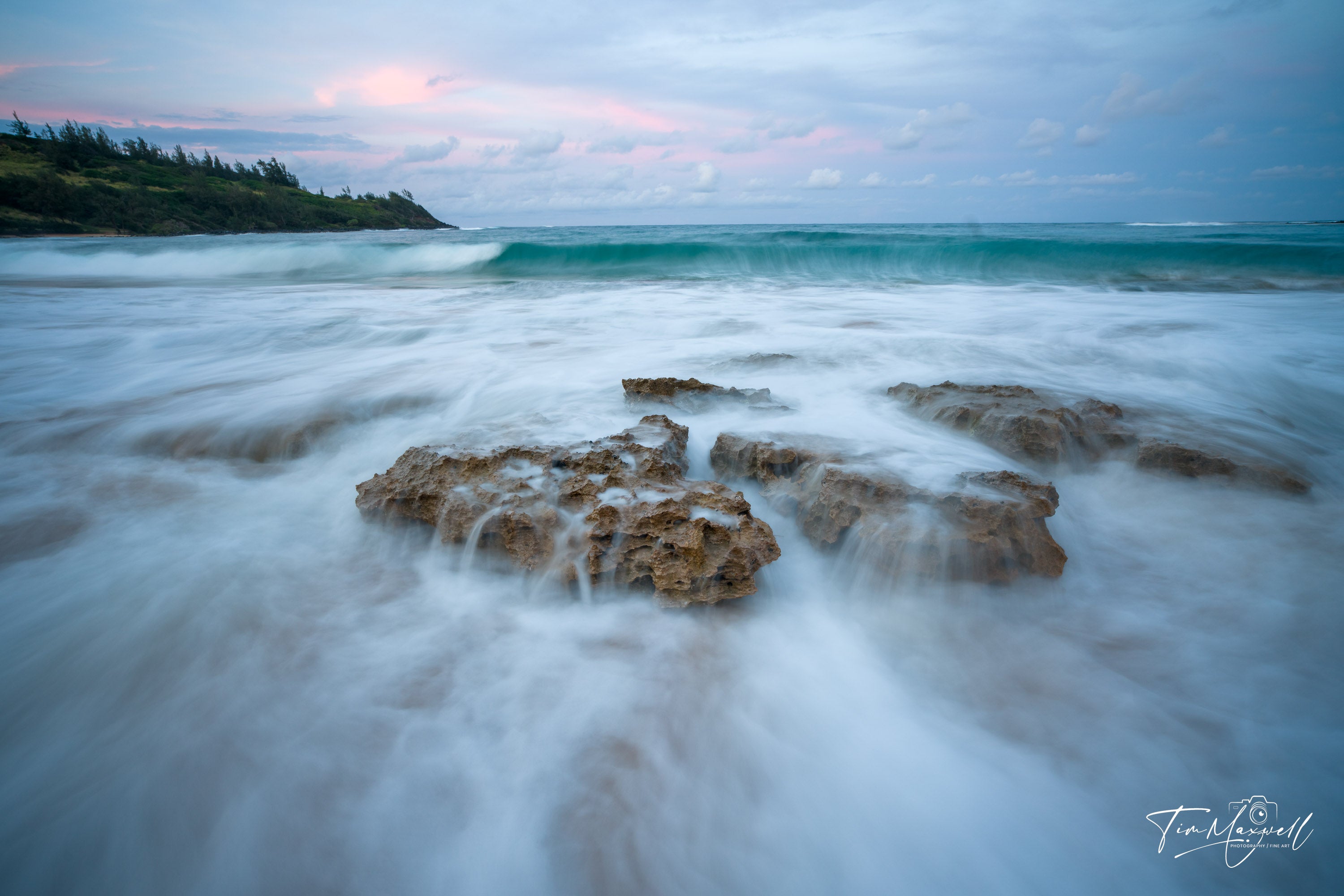 Long-exposure sunset over rocky shoreline in Kauai with pastel sky, fine art print by Tim Maxwell.