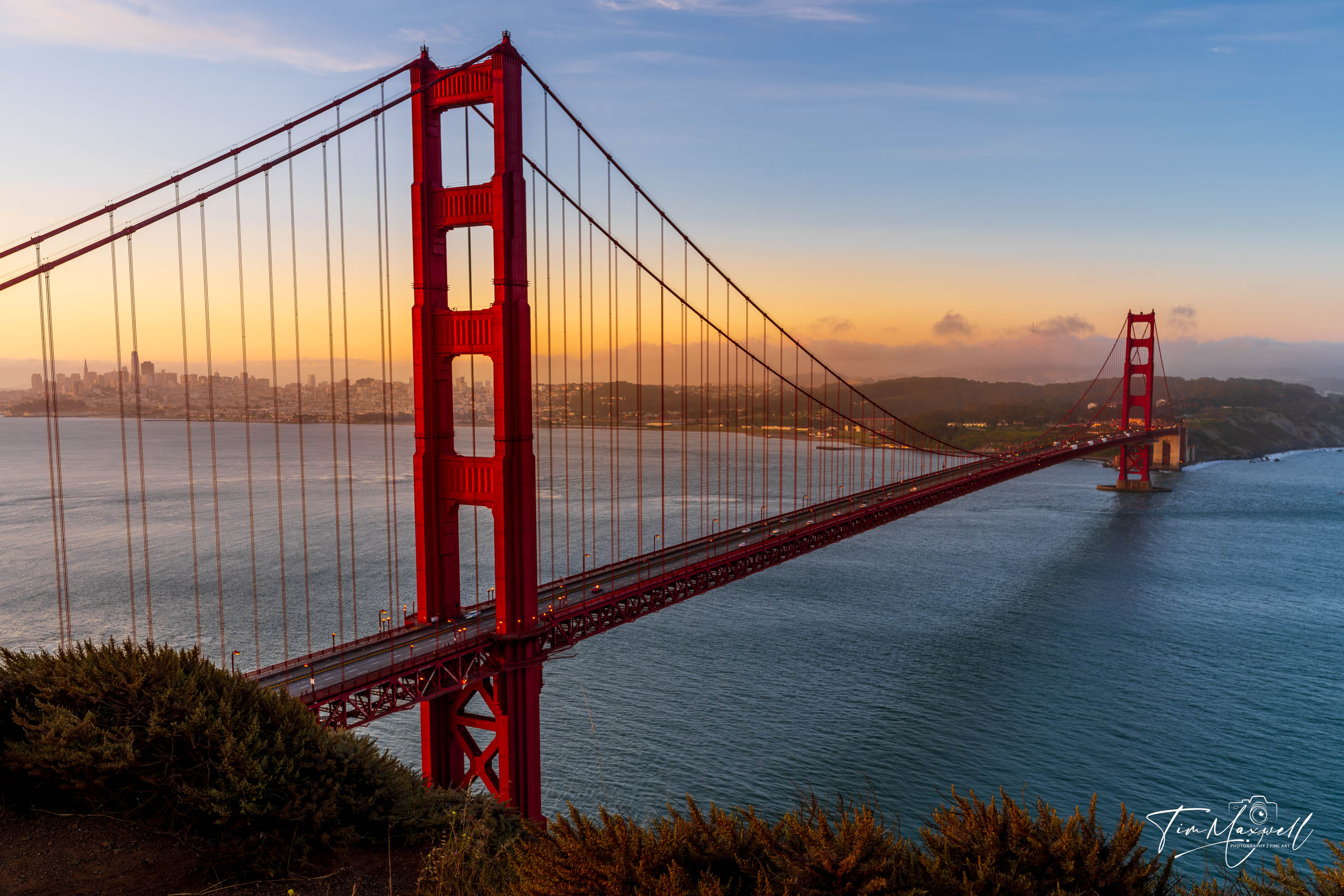 Golden Gate Bridge at sunrise viewed from Battery Spencer with warm morning light over the San Francisco Bay