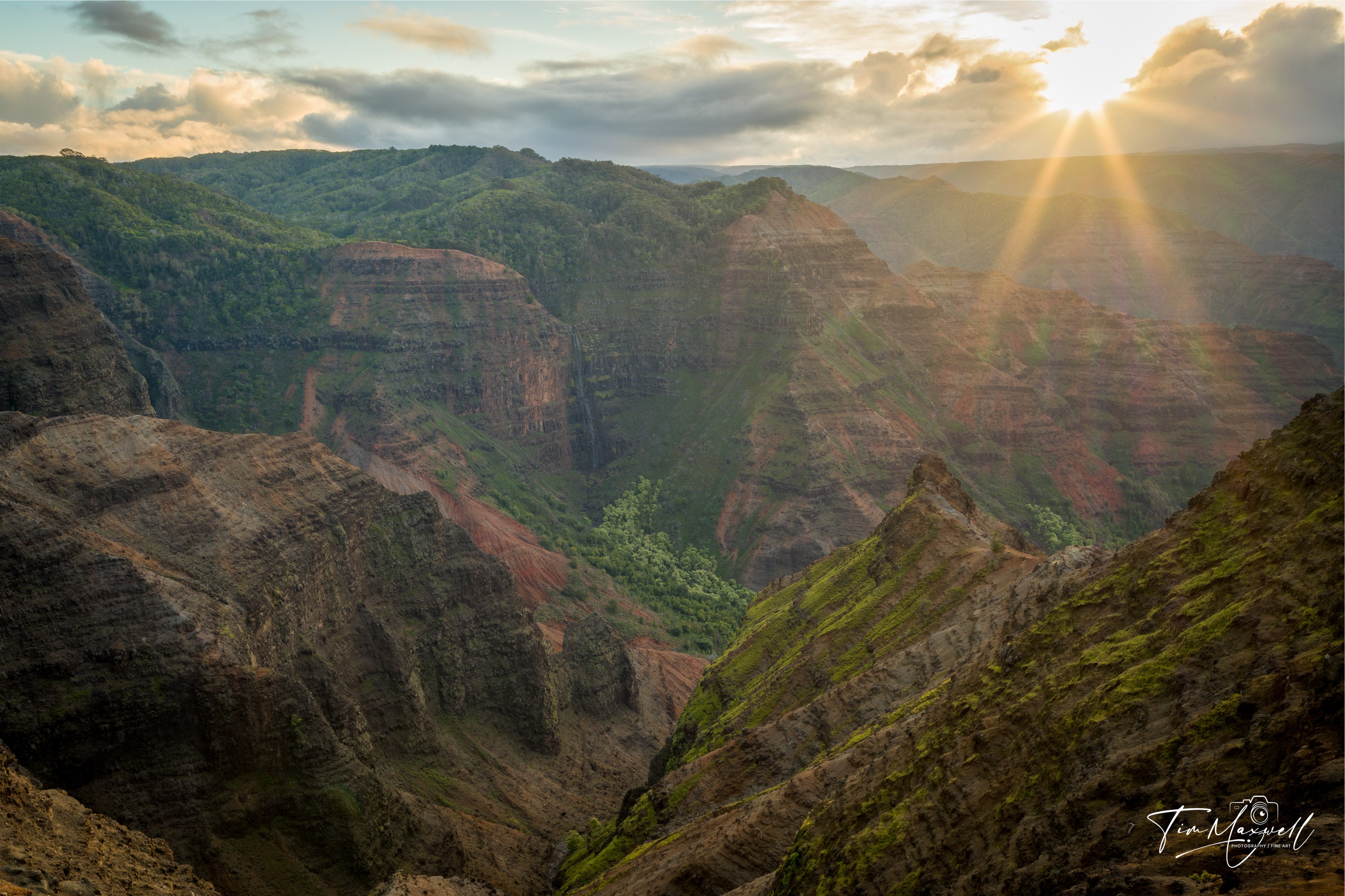 Sunrise light over Waimea Canyon in Kauai, highlighting layered ridges and vibrant colors, fine art print by Tim Maxwell.